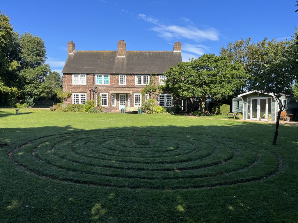 The Living Well house with the garden and its labyrinth in the foreground